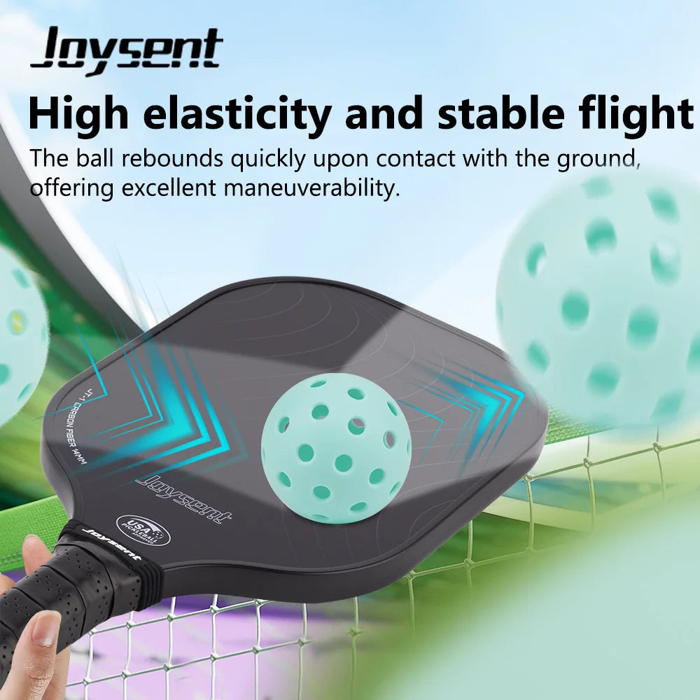 Joysent pickleball paddle with a green ball on a blurred sports court background