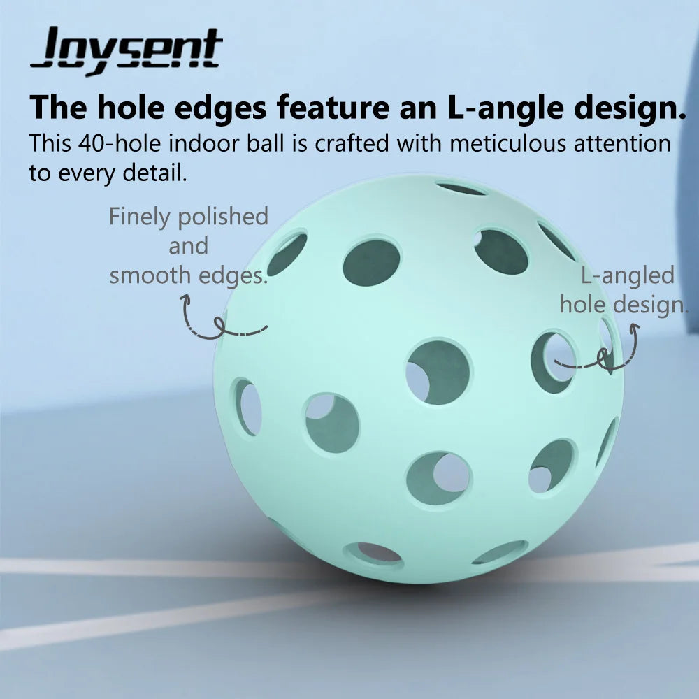 Light blue pickleball with text highlighting design features on a gray surface
