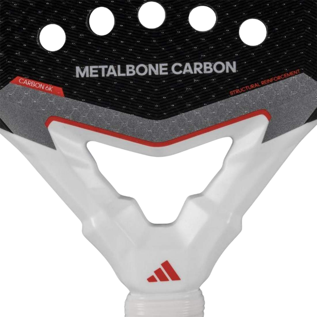 Close-up of a pickleball paddle with 'Metalbone Carbon' branding and Adidas logo.