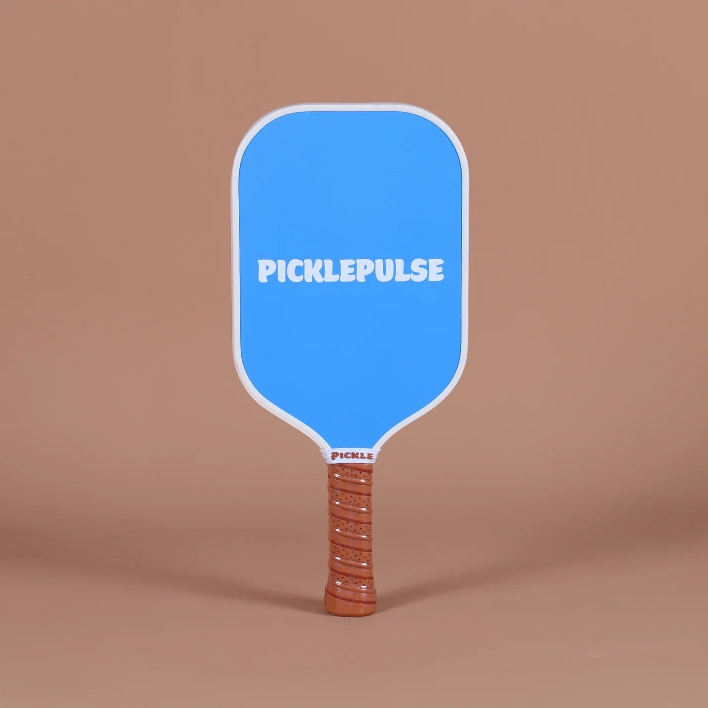 Blue pickleball paddle with 'Picklepulse' branding on a brown background