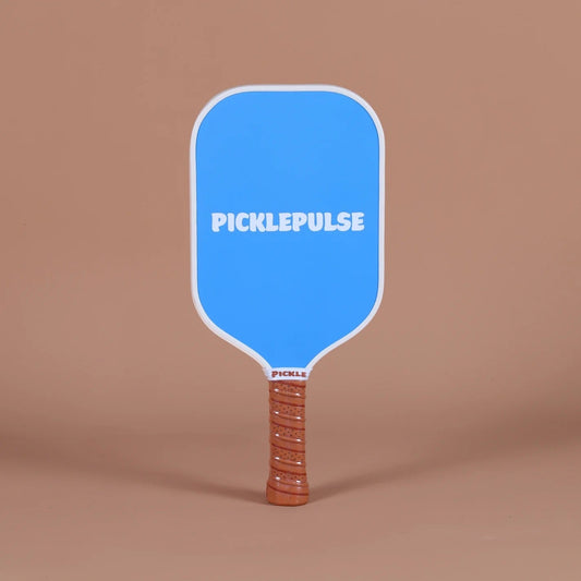 Blue pickleball paddle with 'Picklepulse' branding on a brown background