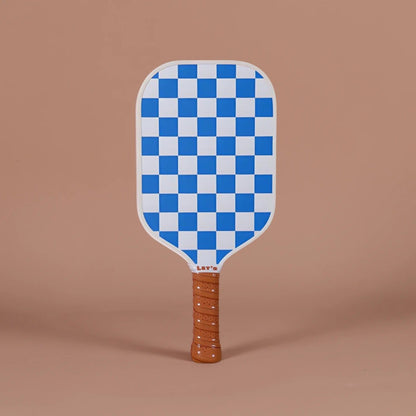 Checkered paddle with a brown handle on a brown background