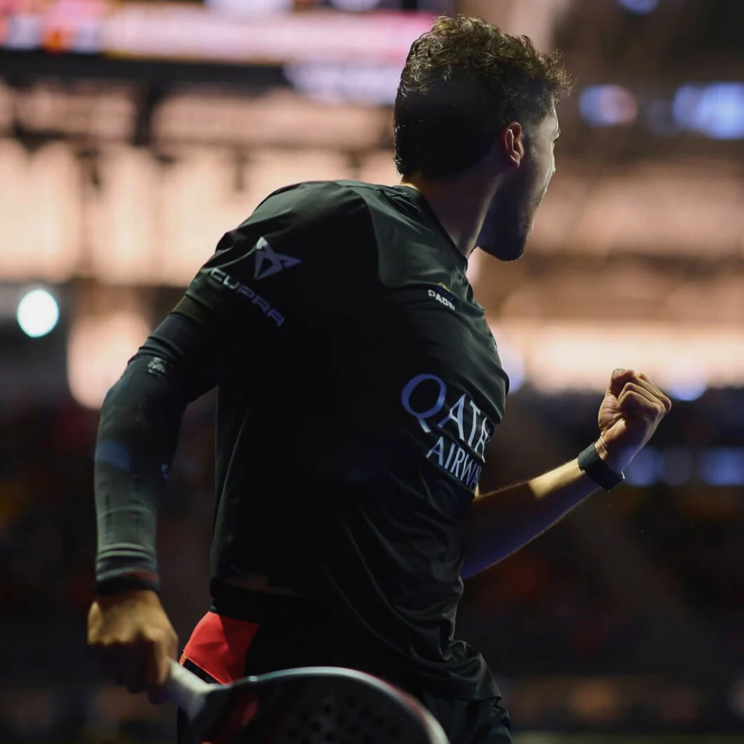 Padel player in action on a court with blurred background
