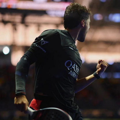 Padel player in action on a court with blurred background