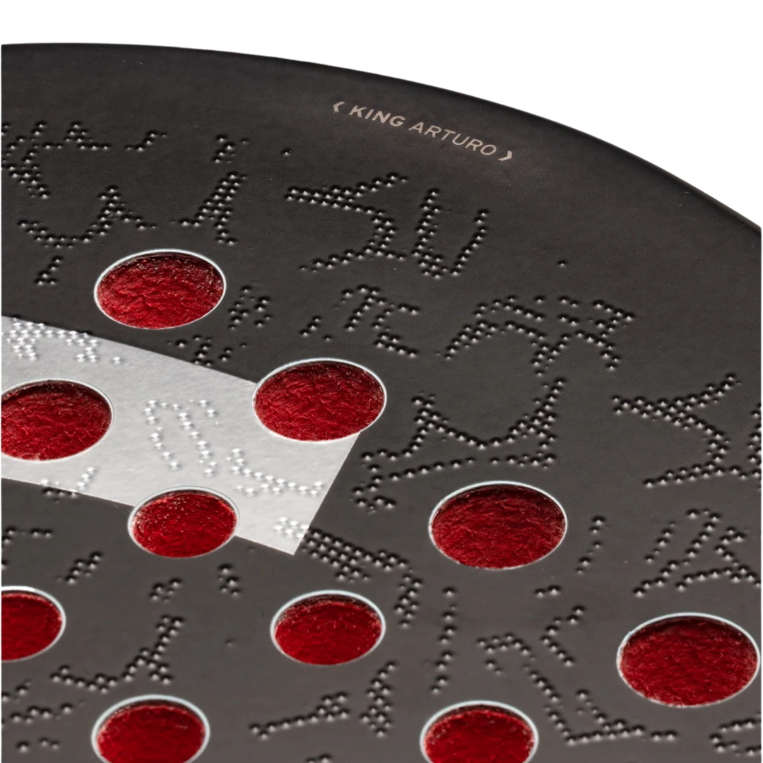 Close-up of a textured surface with red circular patterns and embossed text.