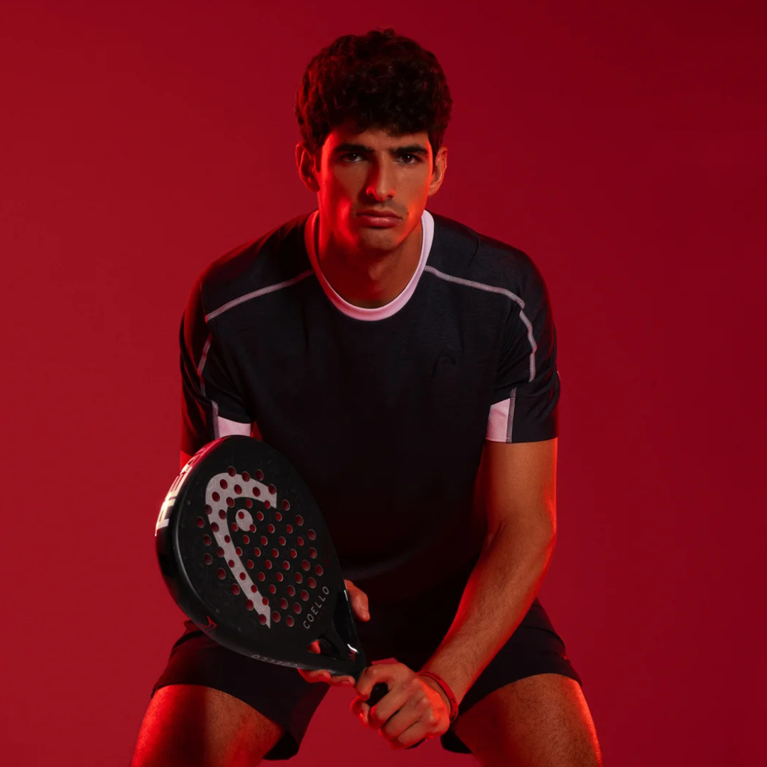 Person holding a paddle against a red background