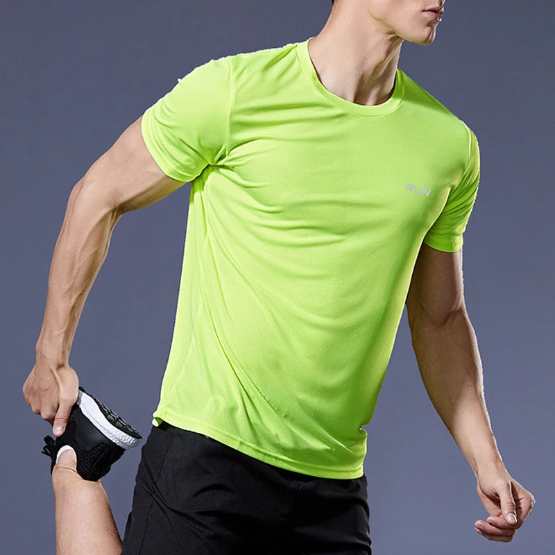 Person wearing a bright green athletic shirt against a dark background