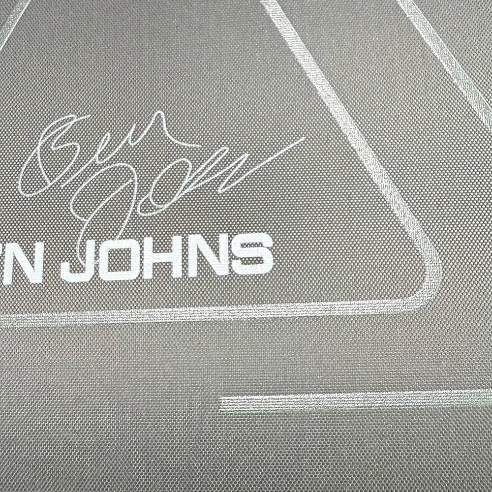 Close-up of a vinyl record with 'Ben Johns' branding on a textured gray background