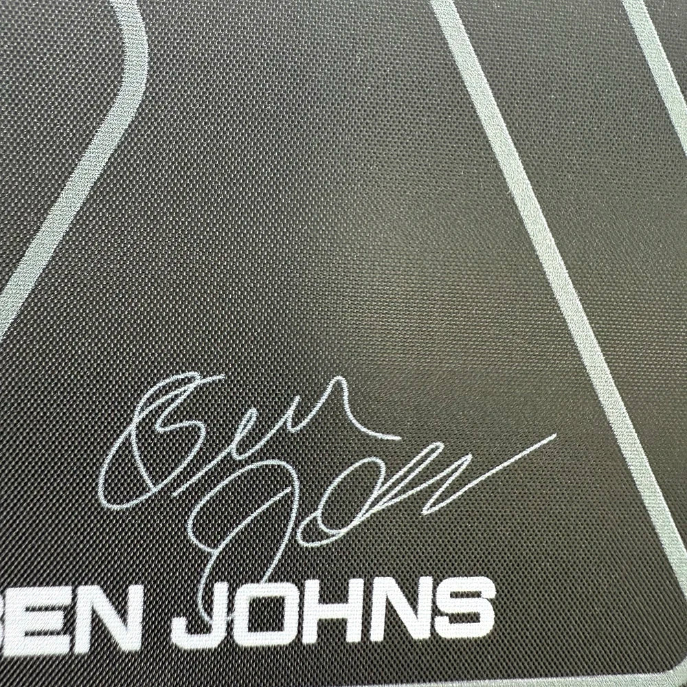 Close-up of a textured surface with 'BEN JOHNS' branding.