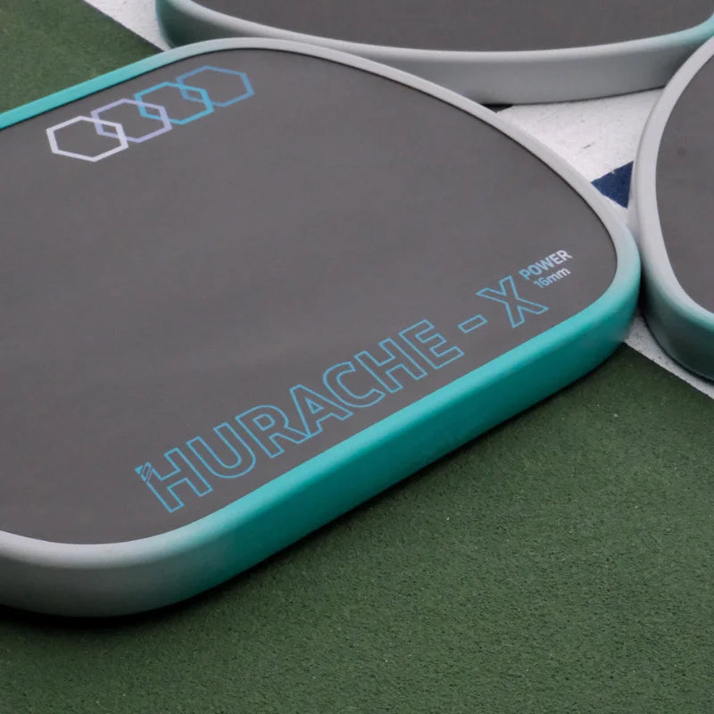 Turquoise and gray Hurache-X drum pad on a green surface