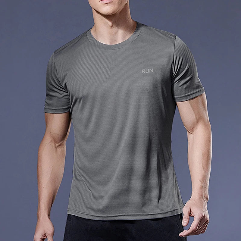 Person wearing a gray athletic t-shirt with 'RUN' text on a dark background