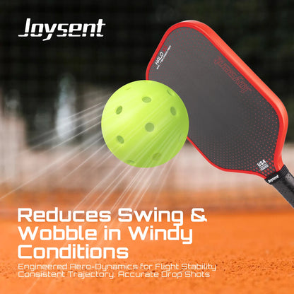 Pickleball paddle and ball with Joysent branding on a blurred court background