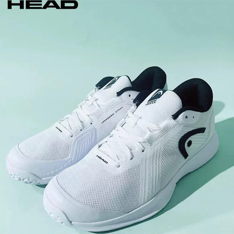 White athletic shoes with black accents on a light green background, featuring the HEAD brand.