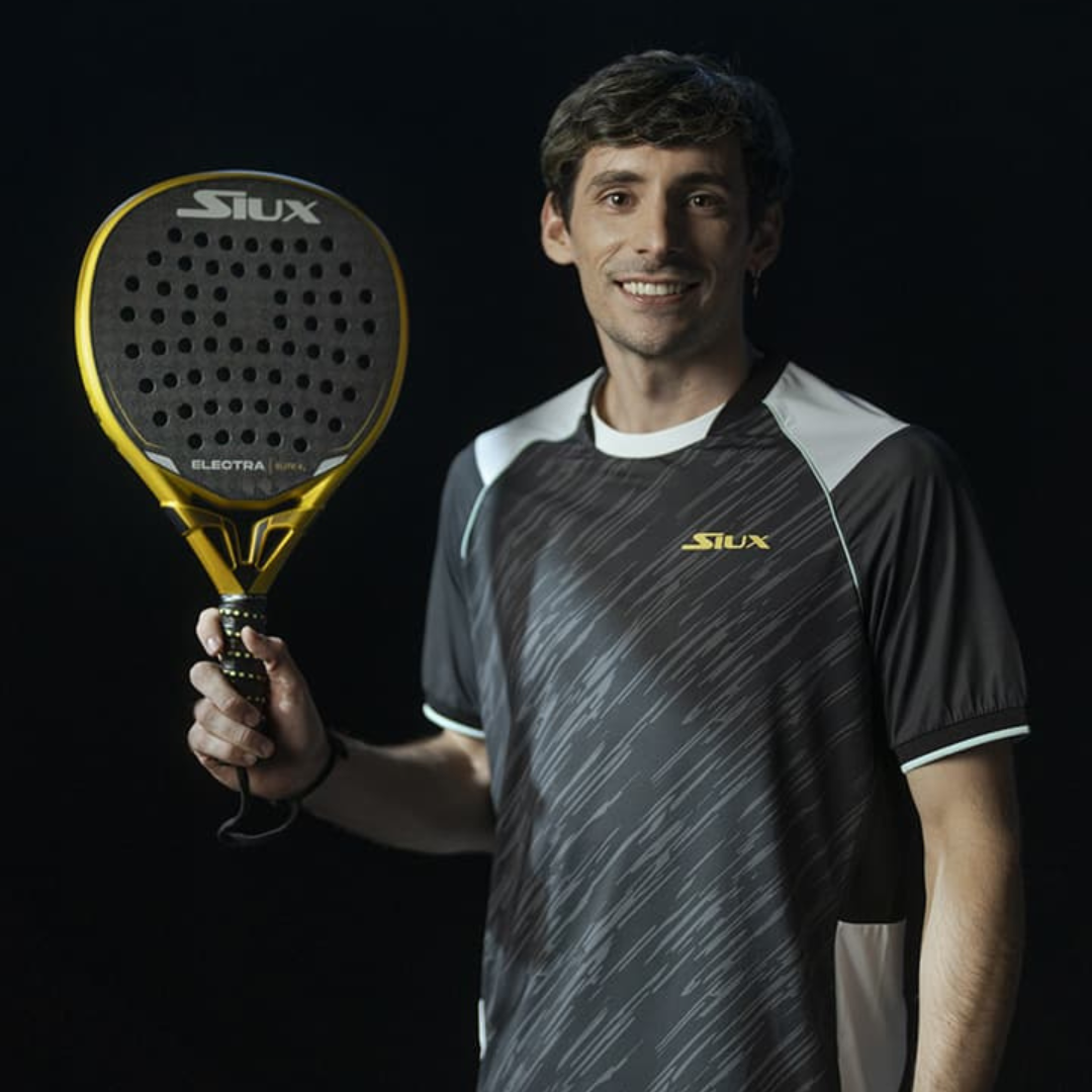 Man holding a Slux branded paddle against a black background