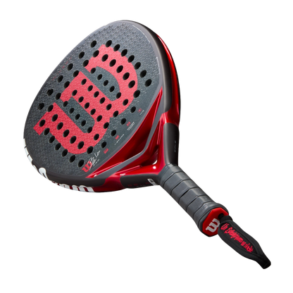 Red and black Wilson tennis racket on a white background