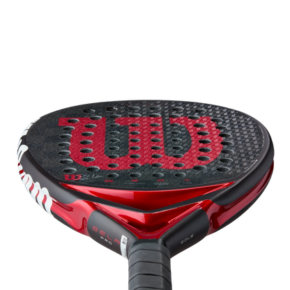 Red and black Wilson tennis racket on a white background