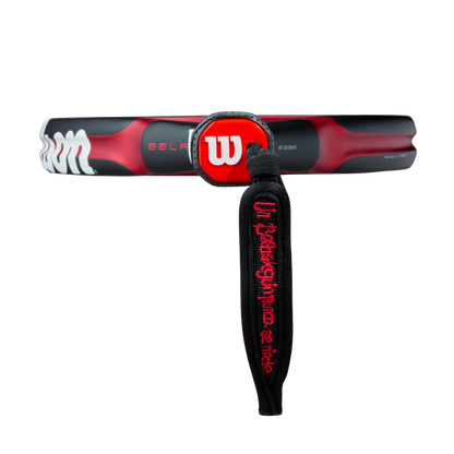 Red and black tennis racket with Wilson branding on a white background