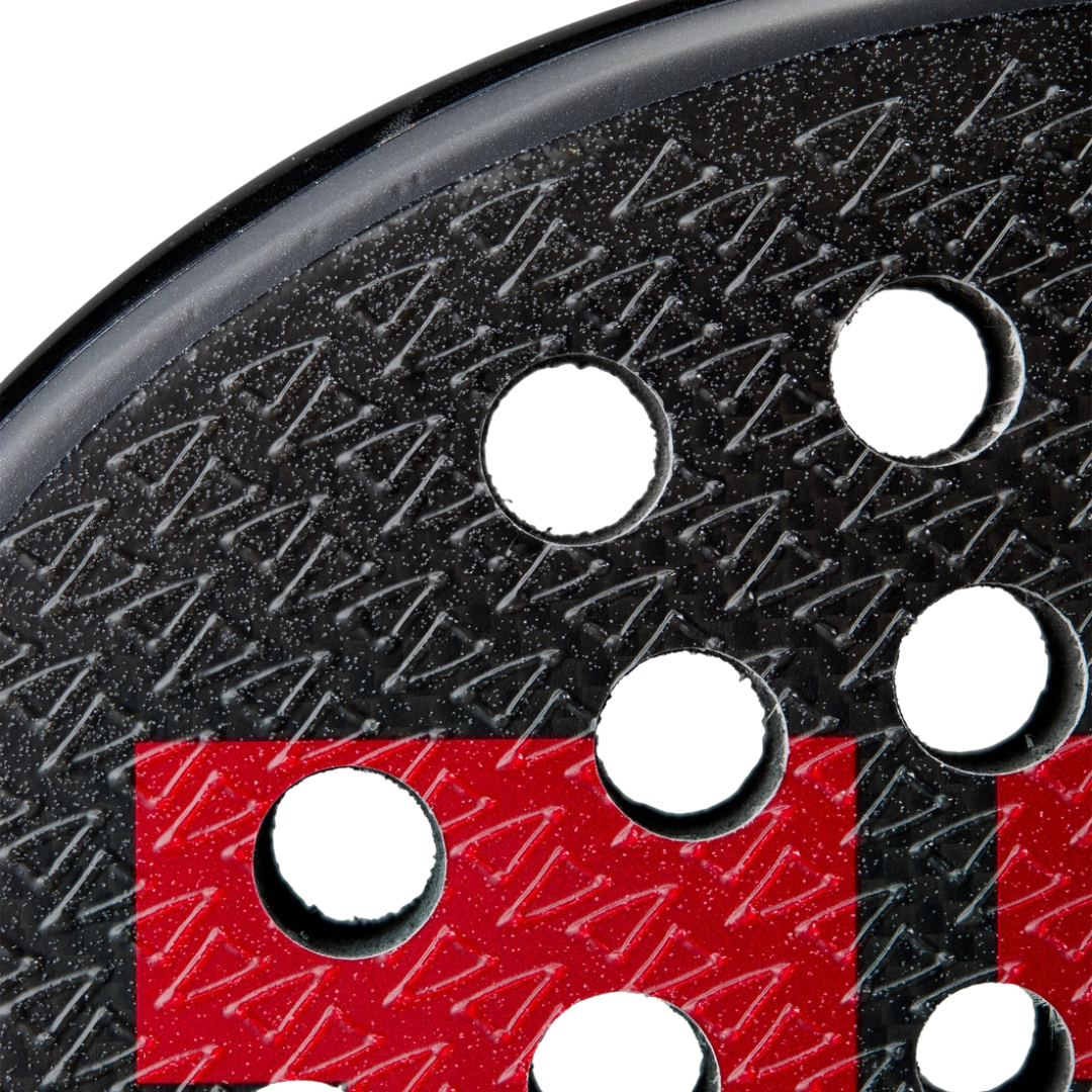 Close-up of a sanding disc with a red and black pattern