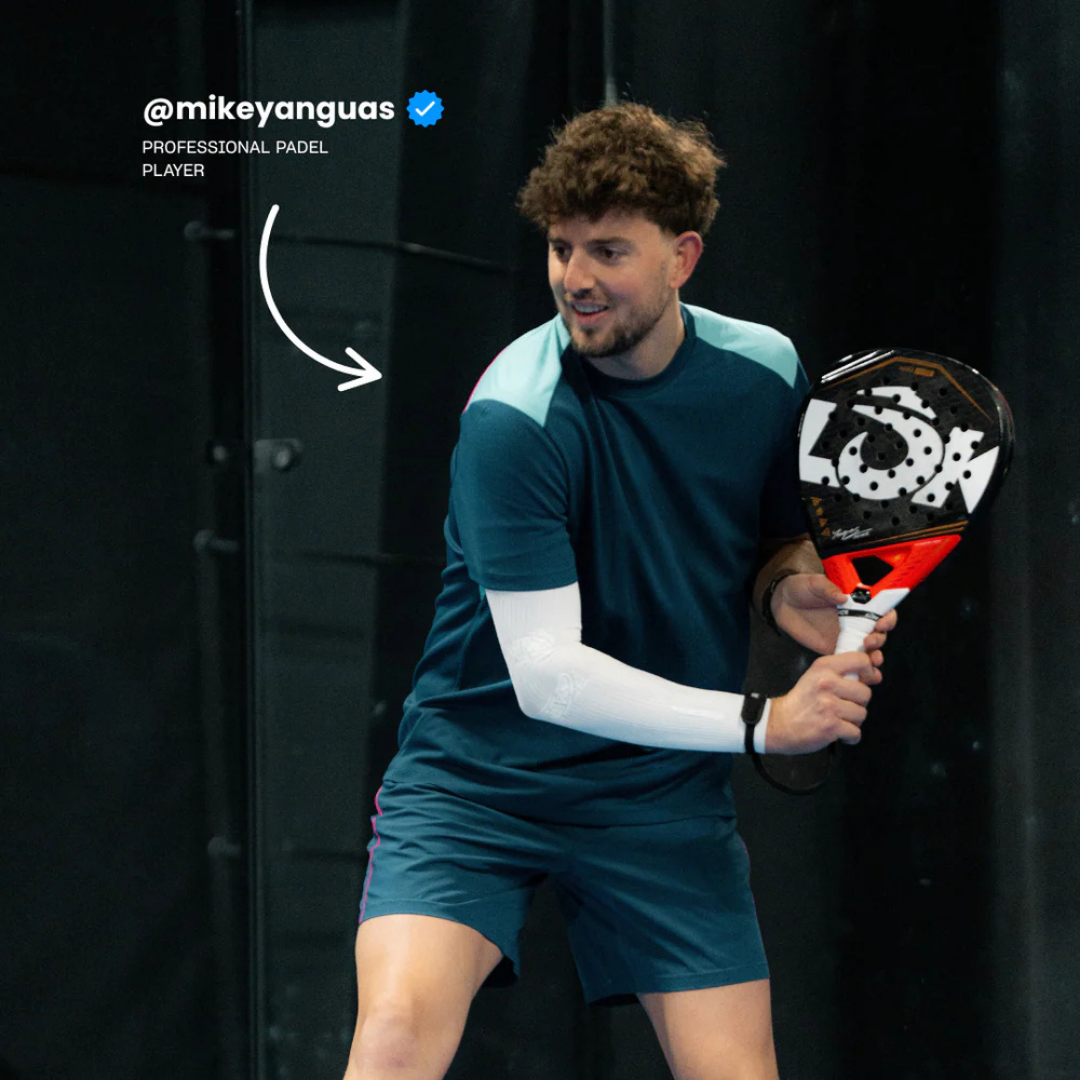 Man holding a paddle with a visible brand logo on a dark background